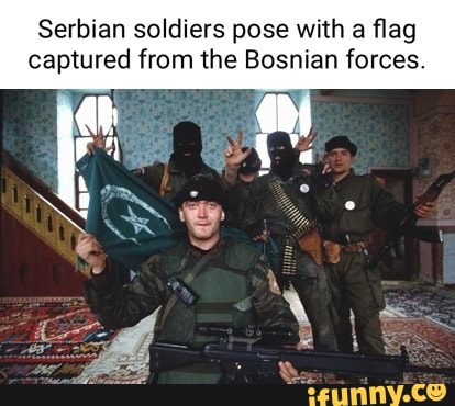 Serbian soldiers pose with a flag captured from the Bosnian forces ...