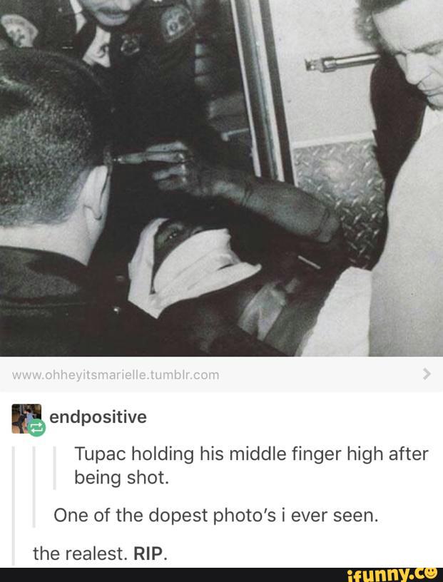 & ty Tupac holding his middle finger high after being shot. 