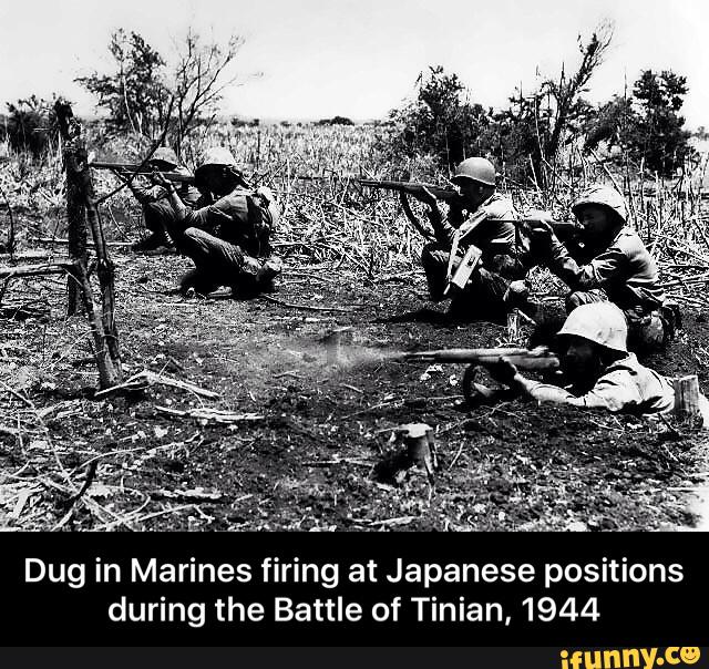 Dug in Marines firing at Japanese positions during the Battle of Tinian ...