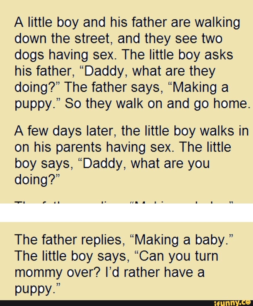 A little boy and his father are walking down the street, and they see two  dogs