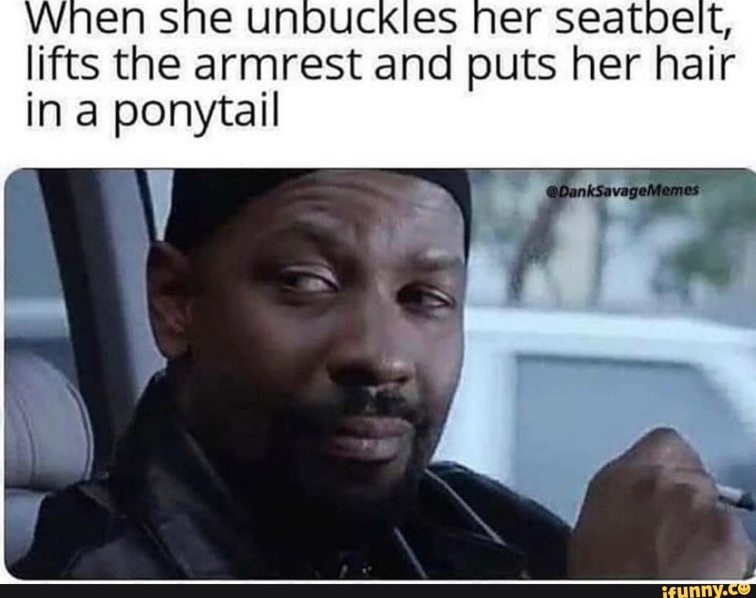 lifts the armrest and puts her hair in a ponytail