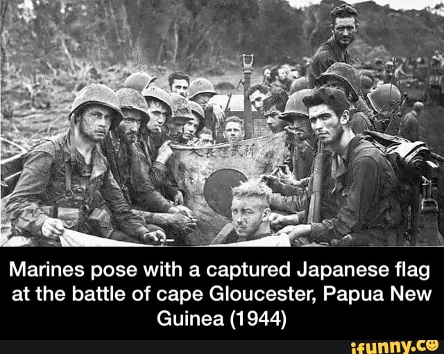 Marines pose with a captured Japanese flag at the battle of cape ...